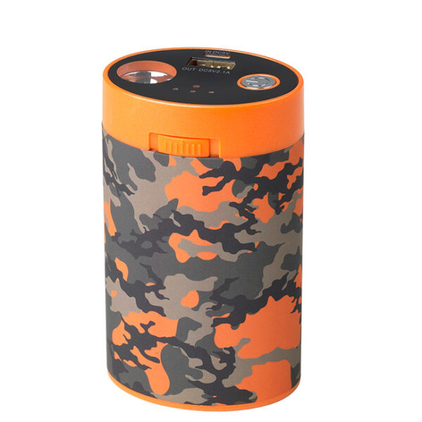 Camouflage-patterned cylindrical battery pack with orange details and charging plug. Use with heated clothing in outdoor activities.