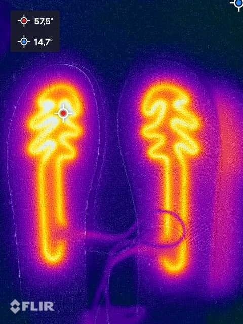 Thermal image shows insoles with heating function, temperatures measured at 57.5°C and 14.7°C, in a warm-to-cold color scale. The Flir logo can be seen at the bottom left.