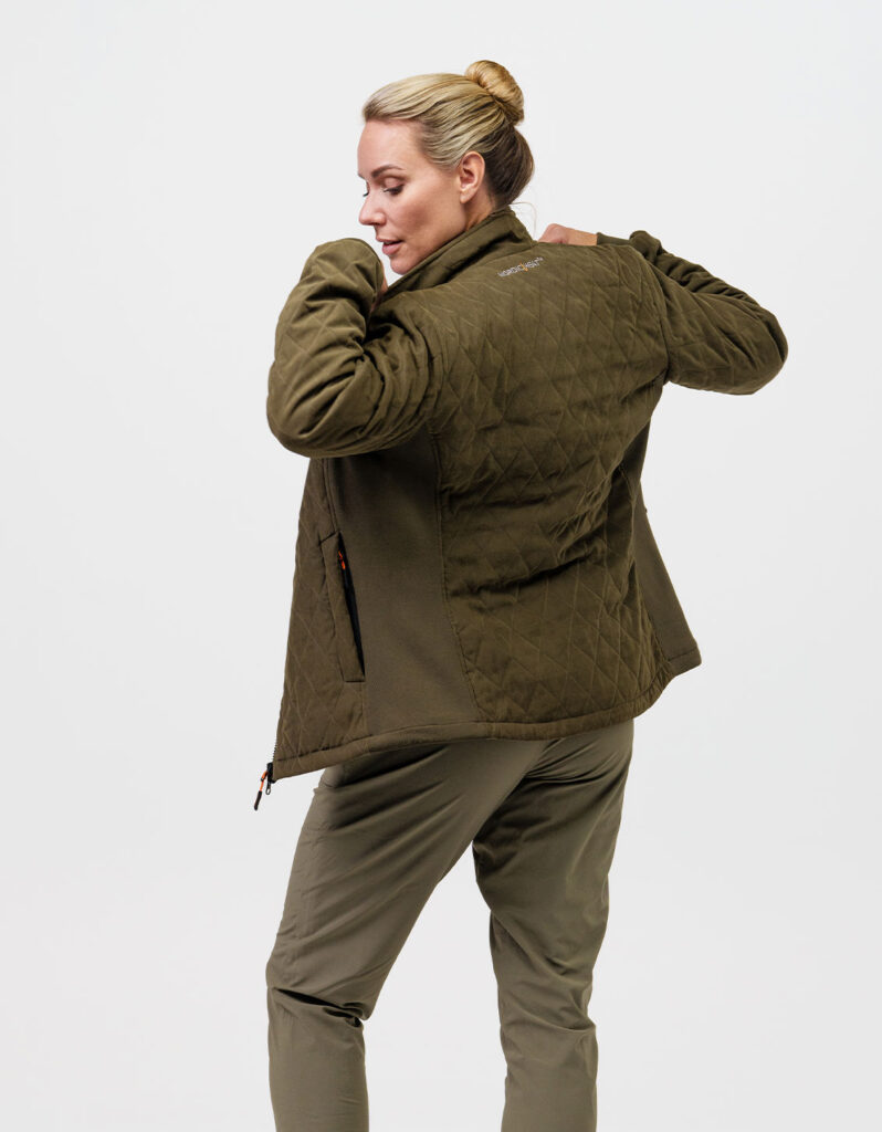 A person wearing a green quilted NordicHeat jacket shows his back. The jacket has the text "nordicheat", signaling warm clothing suitable for active lifestyles in cool climates.