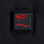 A square plastic button with NordicHeat logo placed on black fabric, probably related to thermal clothing.