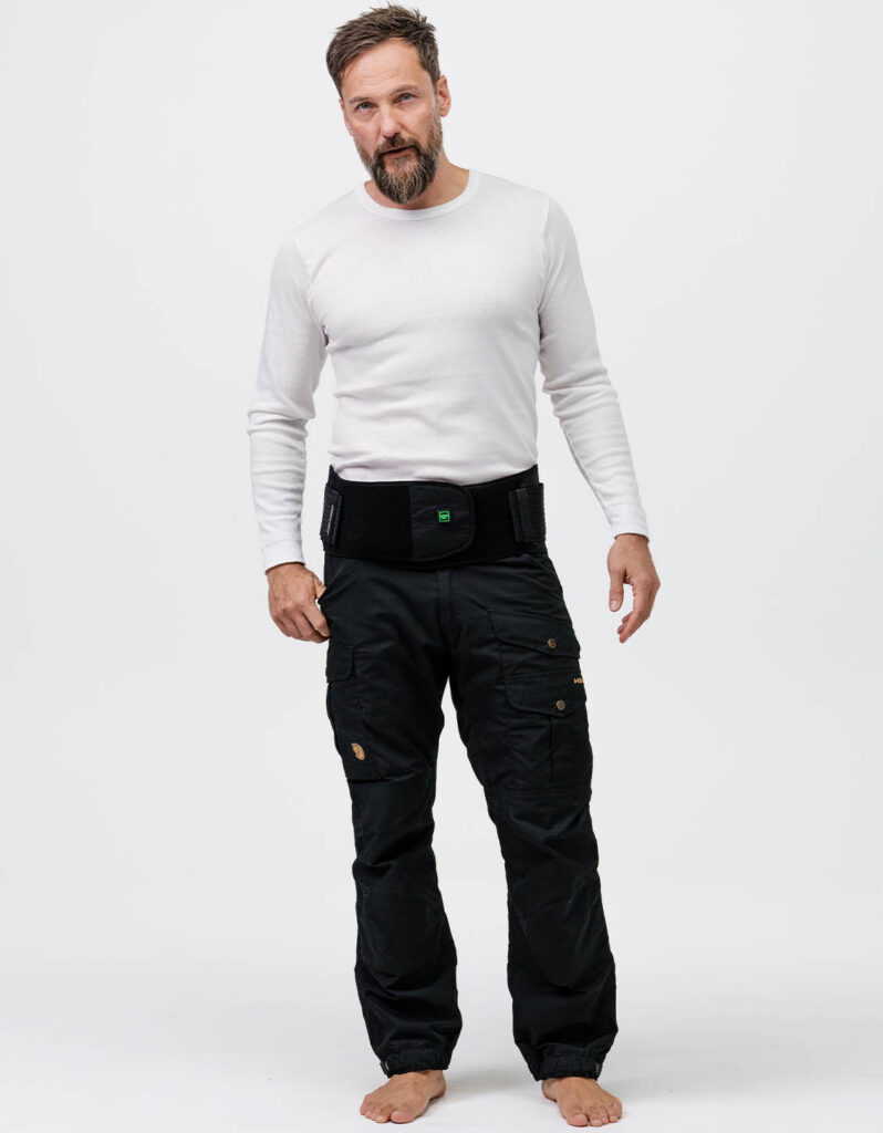 A person wearing NordicHeats warming clothes and warming belt stands in a relaxed pose, signaling the preparation and comfort of an active lifestyle. No visible text.