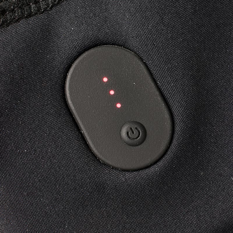 Black fabric with an electronic heat control. An oval button with three red LEDs indicates heat settings.